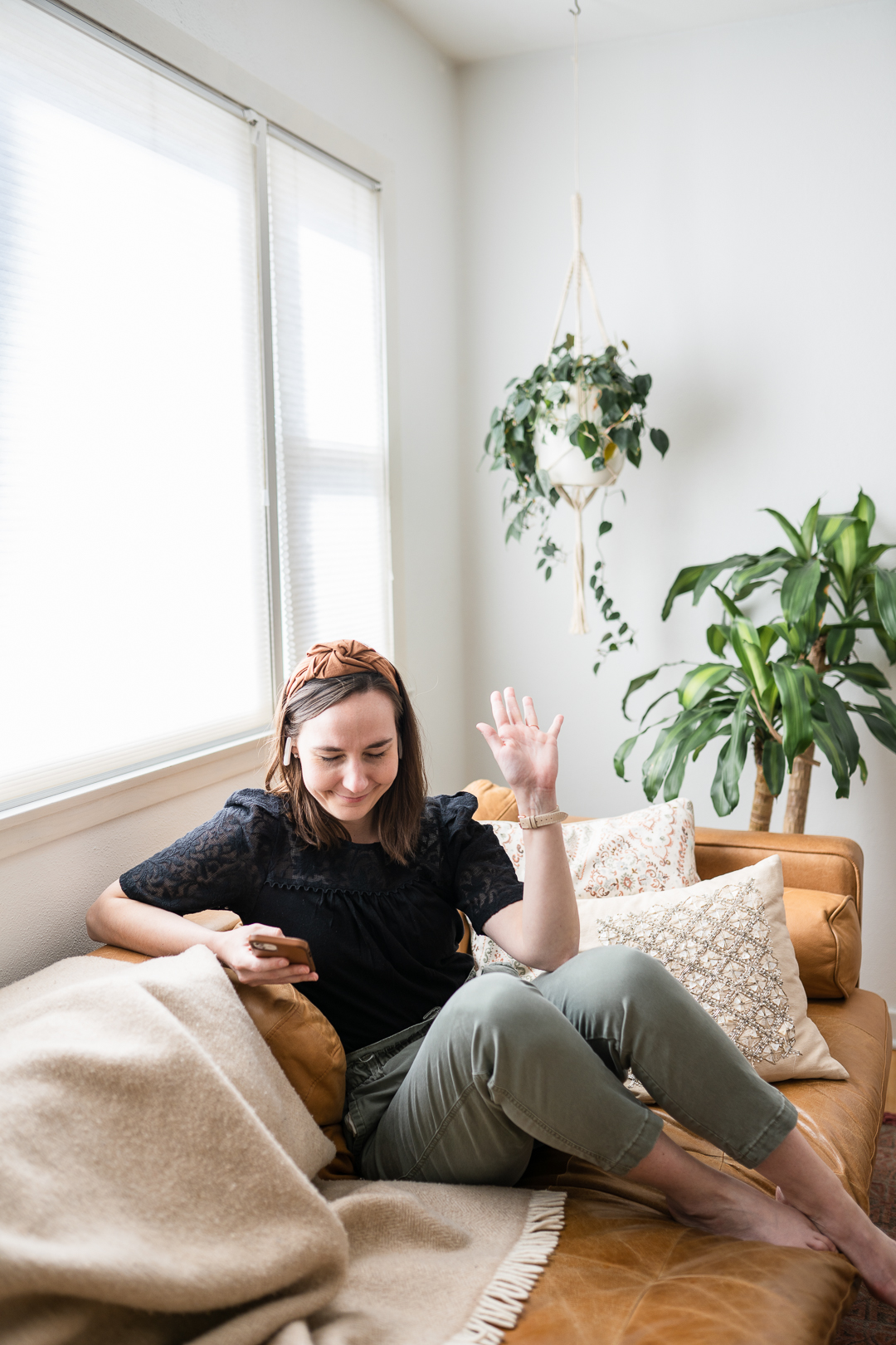 Woman celebrating while listening to a podcast